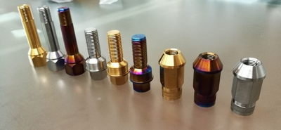 Low weight and high strength titanium lug nuts and wheel bolts
