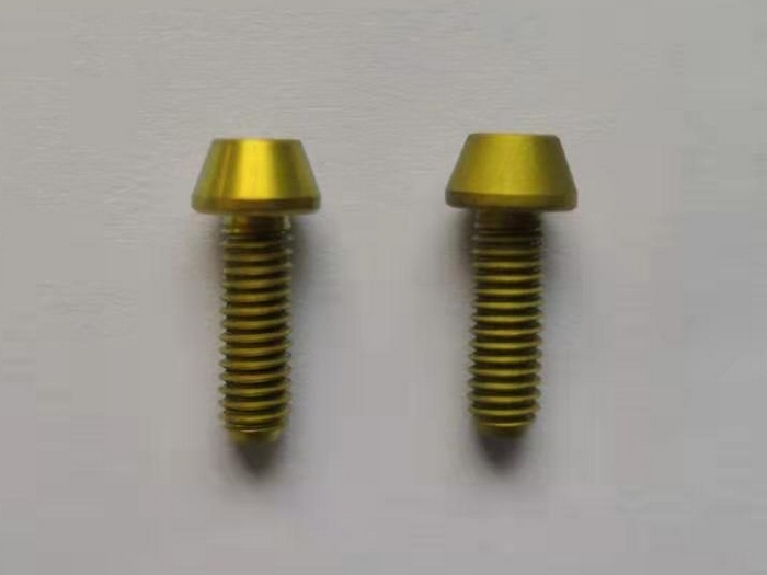 A photo of gold titanium bolts with different finish quality